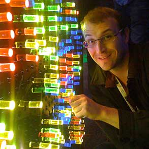 A programmer next to an over-sized Lite-Brite at the Google I/O conference